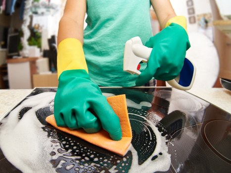 Team member checking cleaning equipment and work area safety